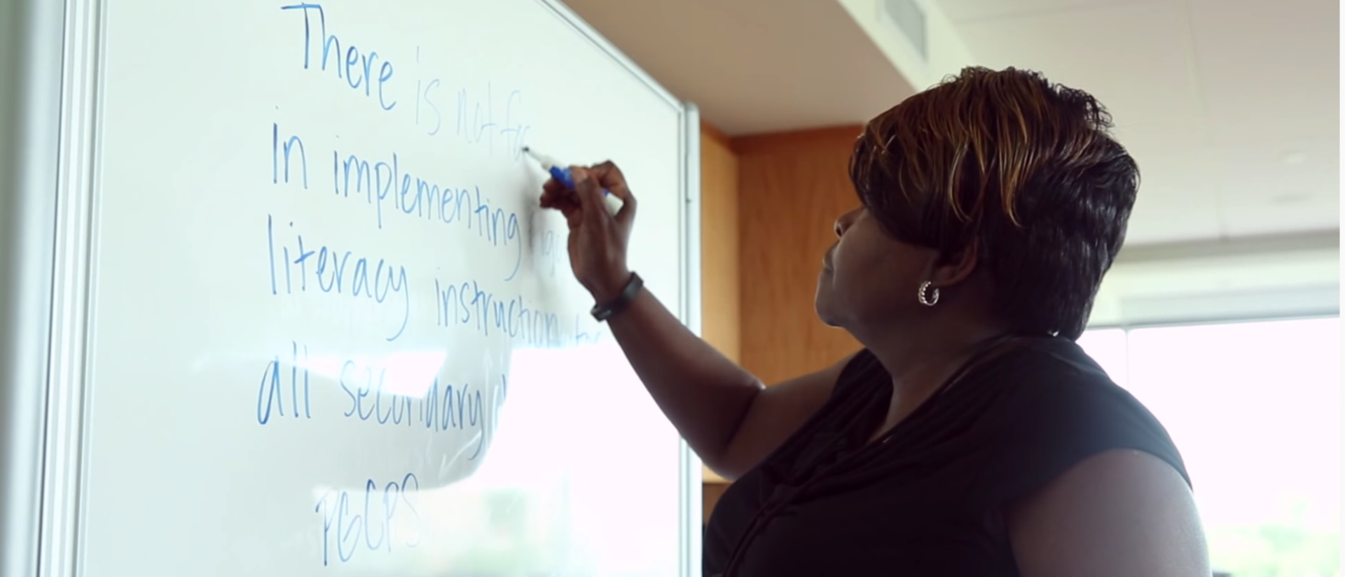 person writing on whiteboard